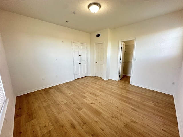 unfurnished bedroom with light hardwood / wood-style floors