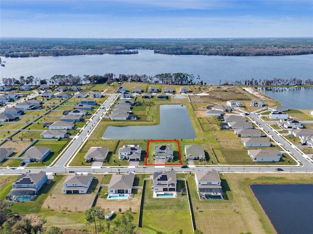 birds eye view of property with a water view