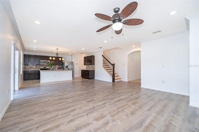 unfurnished living room with crown molding, ceiling fan, and light hardwood / wood-style flooring