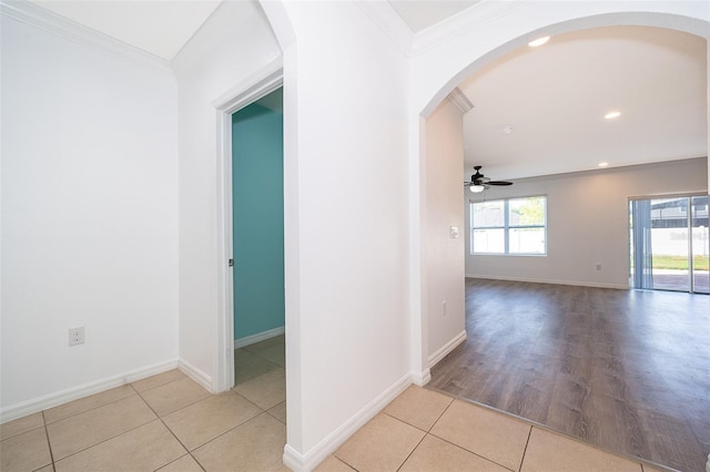 hallway featuring crown molding and light tile patterned floors