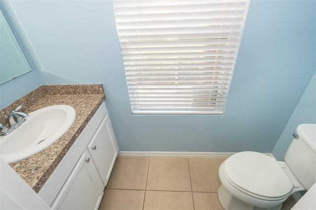 bathroom featuring vanity, tile patterned floors, and toilet