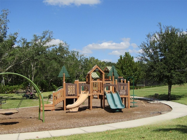 view of jungle gym featuring a lawn