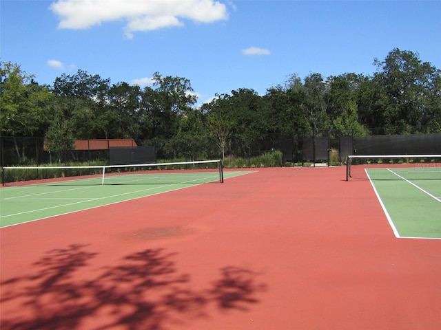 view of tennis court with basketball hoop