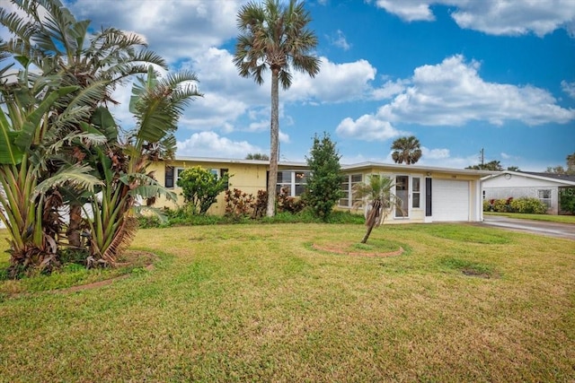 ranch-style house with a front yard, driveway, and an attached garage