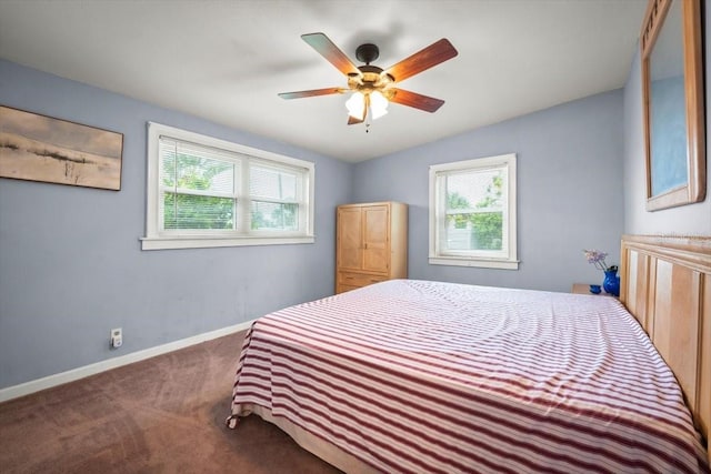 carpeted bedroom with lofted ceiling, multiple windows, baseboards, and a ceiling fan