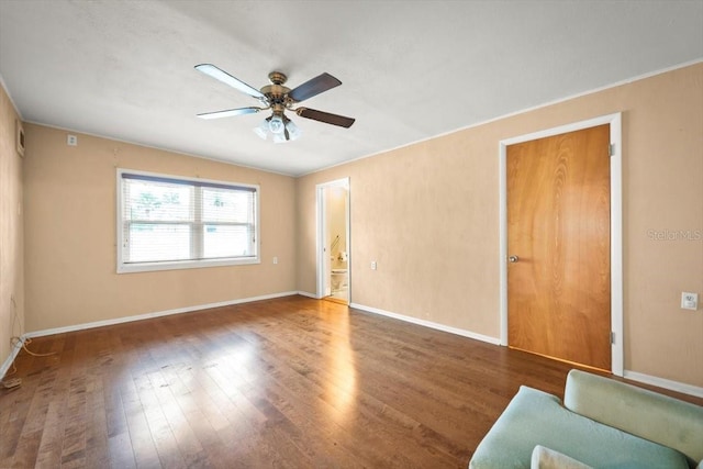 spare room with ceiling fan, baseboards, and wood finished floors