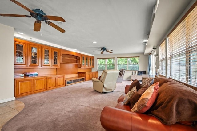 living area featuring light carpet, a ceiling fan, and recessed lighting