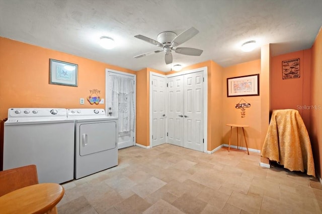 washroom featuring washer and dryer, laundry area, ceiling fan, and baseboards