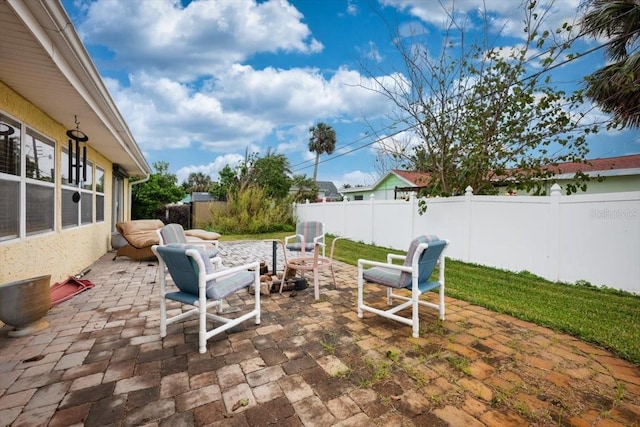 view of patio with an outdoor fire pit and a fenced backyard