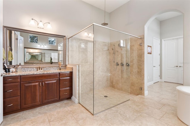 bathroom featuring vanity and a shower with shower door