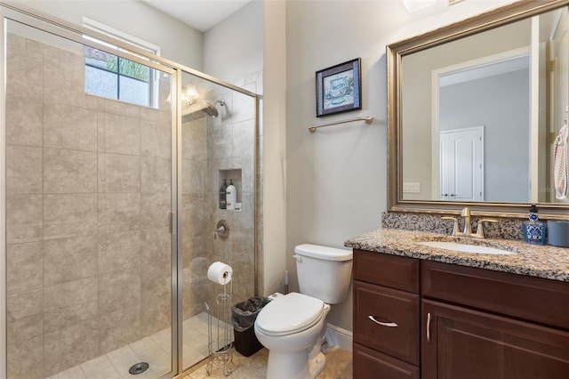 bathroom with vanity, toilet, and an enclosed shower