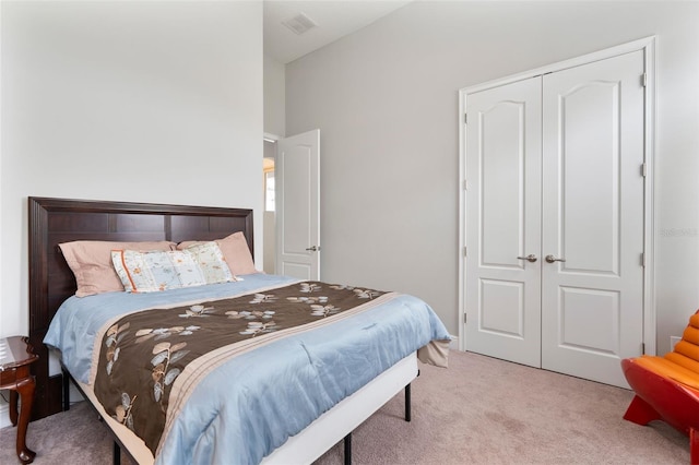 bedroom with light colored carpet and a closet