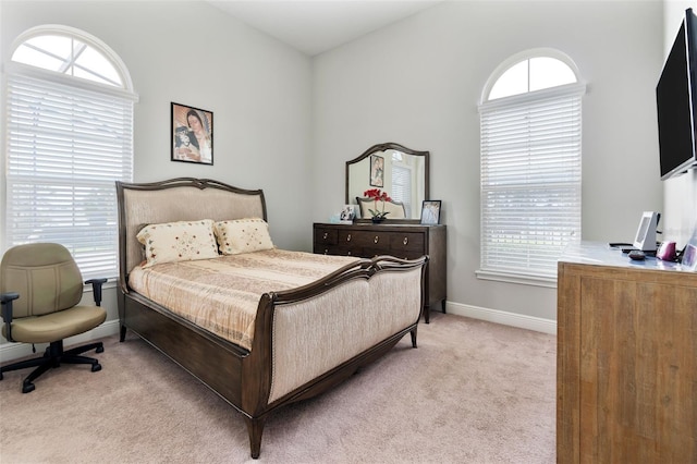 carpeted bedroom featuring multiple windows