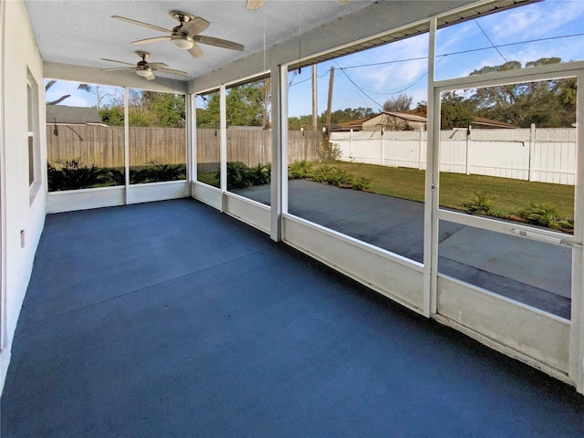 unfurnished sunroom featuring ceiling fan