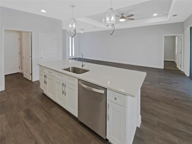 kitchen featuring sink, a kitchen island with sink, white cabinetry, a tray ceiling, and stainless steel dishwasher