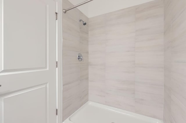 full bath with a tile shower