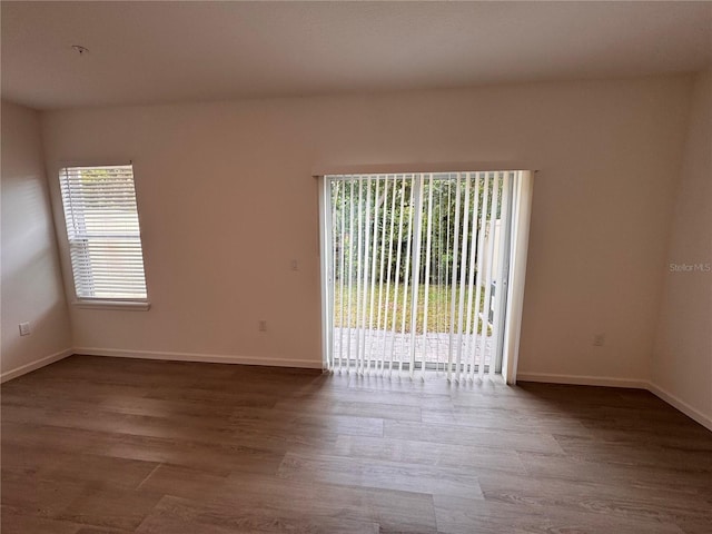 empty room featuring wood finished floors and baseboards