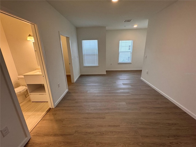 interior space featuring recessed lighting, visible vents, baseboards, and dark wood finished floors