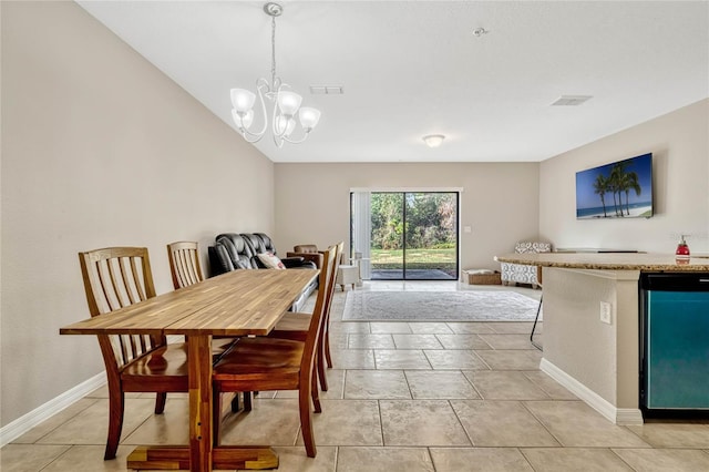tiled dining area with lofted ceiling and a chandelier