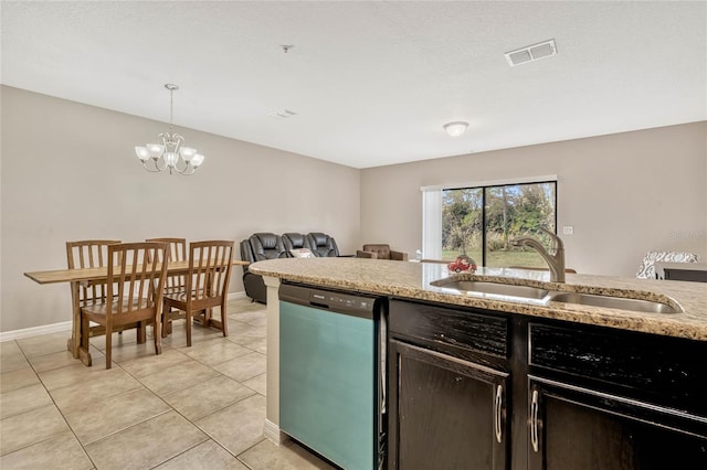 kitchen with sink, light tile patterned floors, hanging light fixtures, light stone counters, and stainless steel dishwasher
