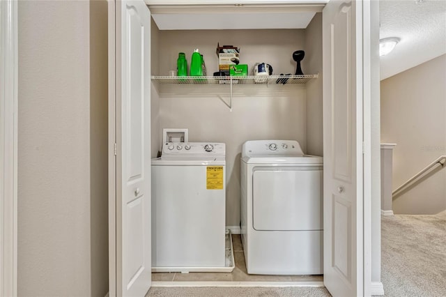 clothes washing area featuring separate washer and dryer and light colored carpet