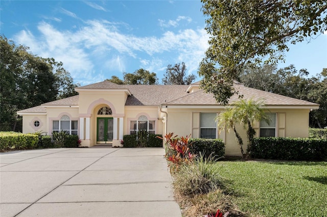 126 Seville Chase Dr, Winter Springs, FL 32708 - mediterranean / spanish-style home featuring stucco siding, a front yard, and a shingled roof