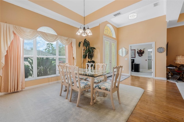 126 Seville Chase Dr, Winter Springs, FL 32708 - dining room featuring baseboards, a towering ceiling, a chandelier, and wood finished floors
