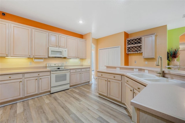 126 Seville Chase Dr, Winter Springs, FL 32708 - kitchen featuring white appliances, a sink, light countertops, light wood finished floors, and recessed lighting