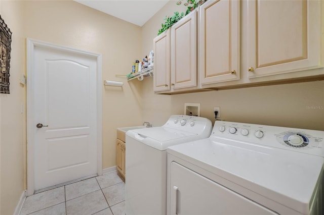 126 Seville Chase Dr, Winter Springs, FL 32708 - laundry area featuring washing machine and dryer, light tile patterned flooring, baseboards, and cabinet space