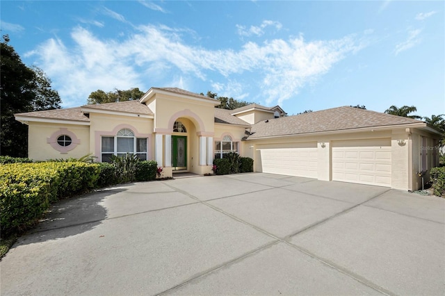 126 Seville Chase Dr, Winter Springs, FL 32708 - mediterranean / spanish house featuring driveway, an attached garage, and stucco siding