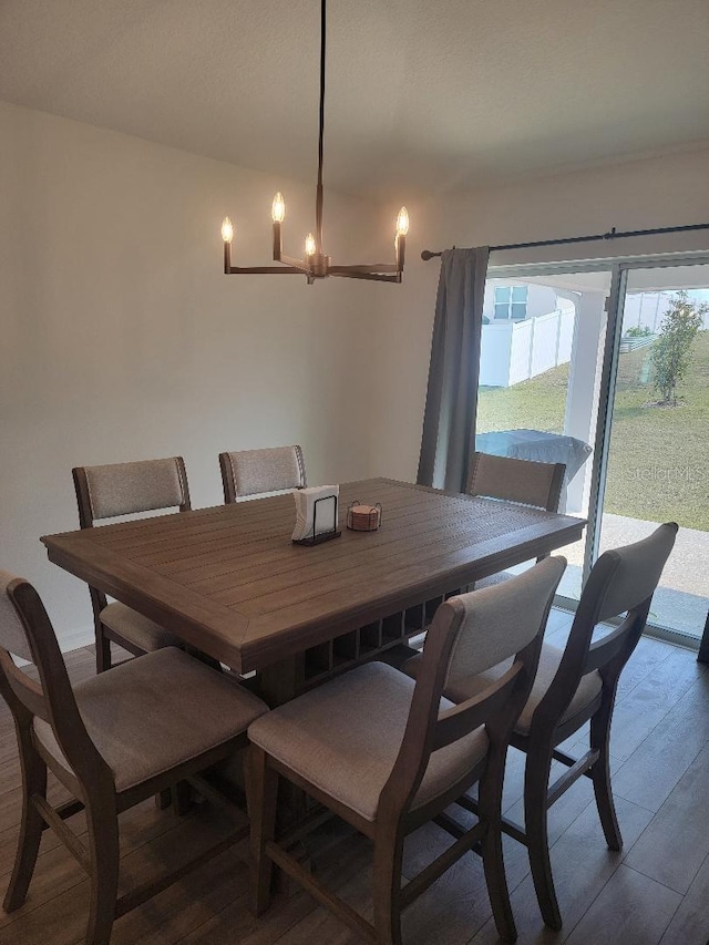 dining space featuring a notable chandelier and dark hardwood / wood-style floors