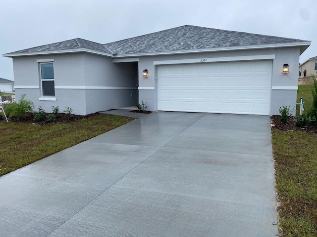 ranch-style home featuring driveway, a shingled roof, and stucco siding