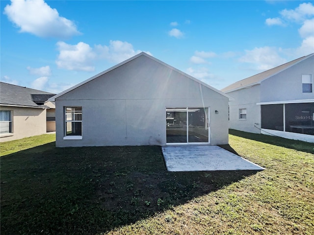 back of property featuring a yard and a patio area