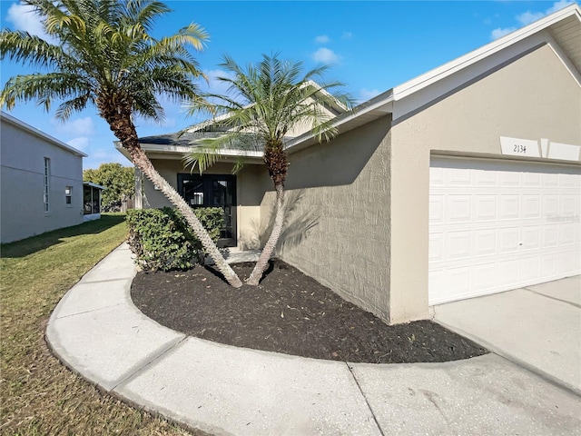 view of side of home featuring a garage