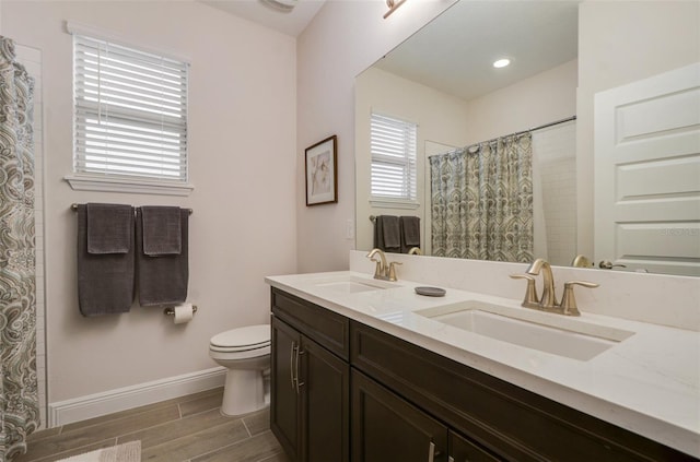 bathroom featuring vanity, toilet, and a shower with shower curtain