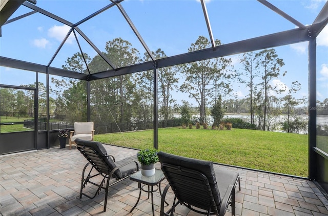 sunroom / solarium featuring a water view