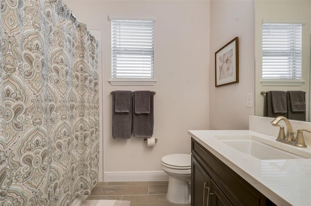17858 Adrift Rd, Winter Garden, FL 34787 - bathroom with toilet, vanity, baseboards, and a shower with shower curtain