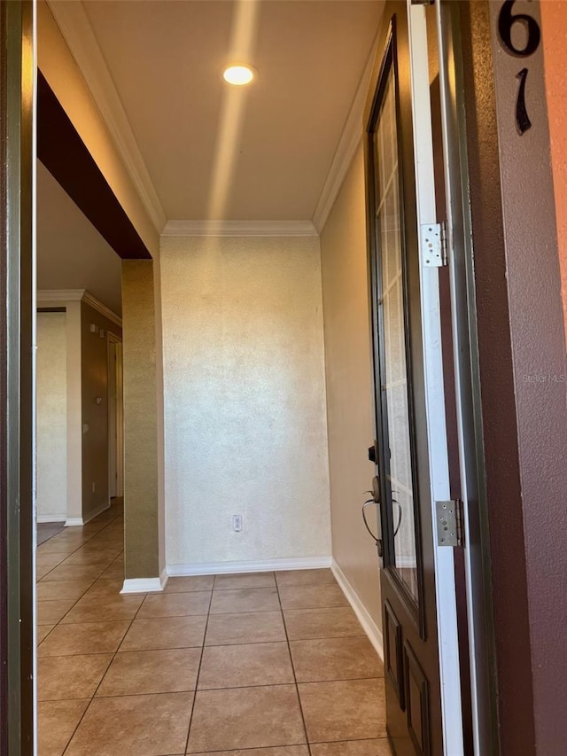 corridor featuring crown molding and light tile patterned flooring