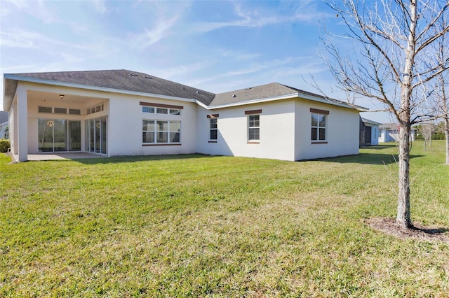 rear view of property with a lawn