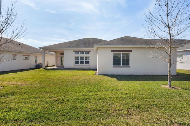 rear view of property featuring central AC, a yard, and a patio area