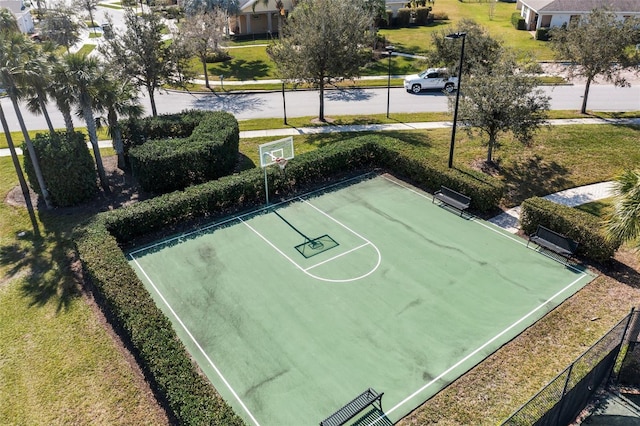 view of basketball court with a lawn