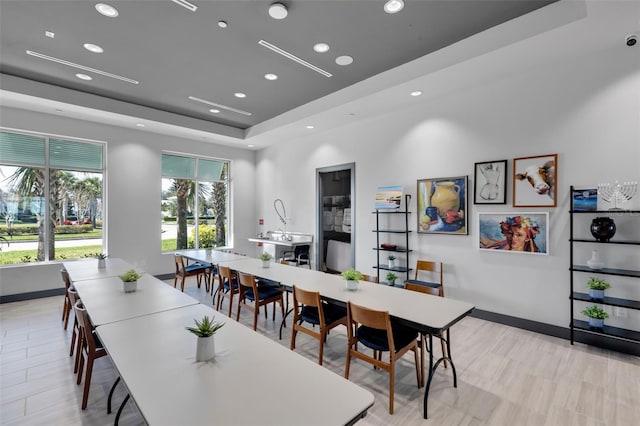 dining space with a raised ceiling