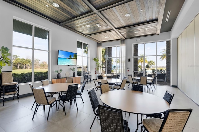 dining room with light tile patterned floors and wooden ceiling