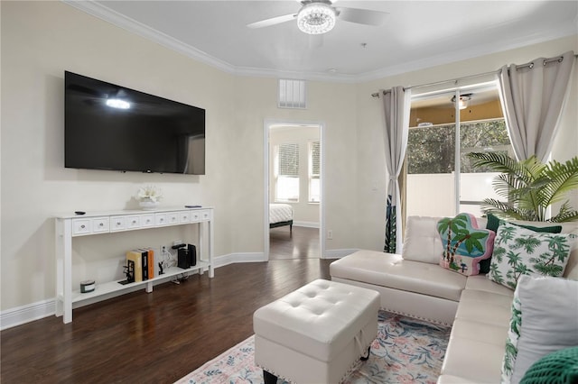 living room featuring ornamental molding, dark wood-type flooring, and ceiling fan