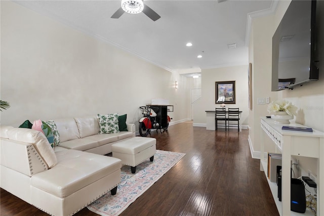 living room with crown molding, dark hardwood / wood-style floors, and ceiling fan