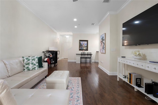 living room with ornamental molding and dark hardwood / wood-style floors