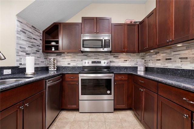 kitchen featuring tasteful backsplash, appliances with stainless steel finishes, sink, and light tile patterned floors