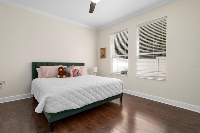 bedroom featuring dark hardwood / wood-style flooring, crown molding, and ceiling fan