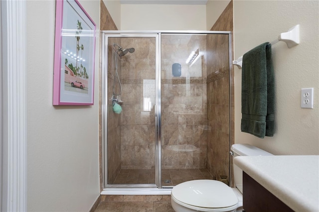 bathroom featuring vanity, toilet, and an enclosed shower