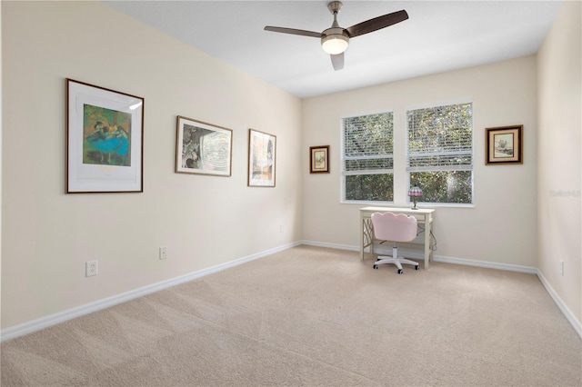 unfurnished office featuring light colored carpet and ceiling fan